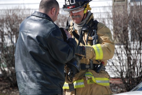 Firefighter returns cat to owner